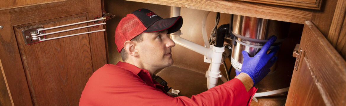 Plumber Cleaning a Garbage Disposal