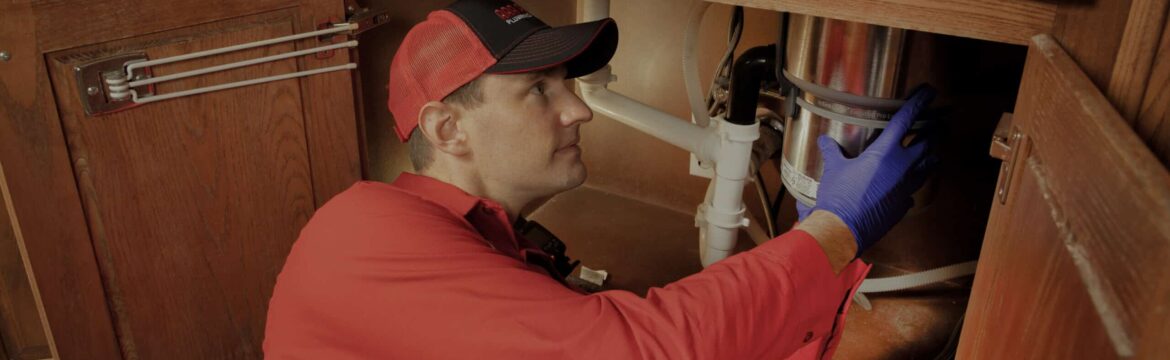 Plumber Cleaning a Garbage Disposal